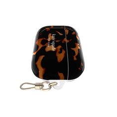 a black and brown animal print case with a caramel colored key chain attached to it