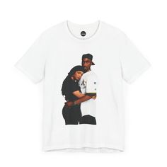 a white t - shirt with an image of two people hugging each other on it