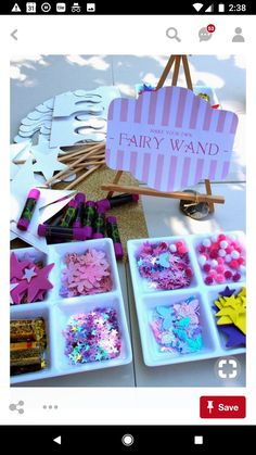 there are many crafting items in the trays on the table and one has a sign that says fairy wands