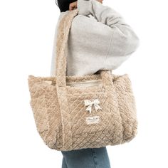 Our Teddy Tote Bag is a cozy and stylish bag that combines every-day convenience with a classic design. It features 3 exterior pockets, and a bow for an added touch of elegance.   The quilted light brown towel exterior is soft and luxurious, complemented by the bear-themed pattern inside.   Ideal for carrying books and groceries, or hauling beach gear and gym clothes, this bag is a must have for anyone who values versatility.  Size: 16" x 12" x 4" Winter Tote, Brown Towel, Mini Makeup Bag, Large Makeup Bag, Tool Bags, Vanity Bag, Beach Gear, Gym Clothes, Large Backpack