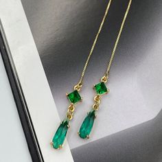 ❤️Deliver gifts on time with our recommended ship-by dates.❤️ - 16 DEC USPS first class mail - 18 DEC USPS Priority mail - 20 DEC USPS Priority mail express Elegant thread earrings featuring radiant emerald green crystals, intricately set to capture light from every angle. These slender drop earrings seamlessly blend classic charm with contemporary design, making them a perfect accessory for both everyday wear and special occasions. Their shimmering hue adds a touch of luxury, effortlessly elevating any ensemble. Measurements: The total length from the top of the hook to bottom - 4.13 inches (105 mm) approximately. Connector crystal: 5 mm x 5 mm Crystals: 12 mm x 4 mm These earrings would be a PERFECT GIFT for you and your family and friends!  Click here to see more Modern Everyday Earring Green Cubic Zirconia Crystal Earrings For Party, Green Cubic Zirconia Party Earrings, Elegant Green Teardrop Earring (single), Elegant Green Teardrop Single Earring, May Birthstone Crystal Drop Earrings, Green Crystal Teardrop Earrings, Green Drop Crystal Earrings For Party, Green Teardrop Crystal Earrings, Green Crystal Drop Earrings For Formal Occasions