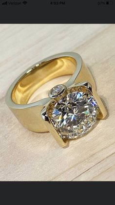 a diamond ring sitting on top of a wooden table