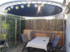 an outdoor dining area with table and chairs