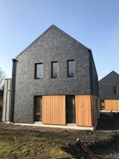 a house that is made out of wood and has three windows on the side of it