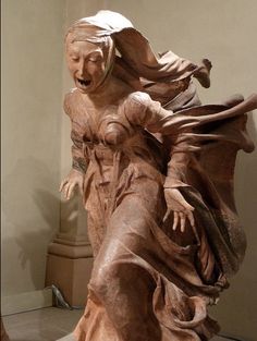 a statue of a woman with her arms outstretched