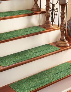 a set of stairs with green carpet on them