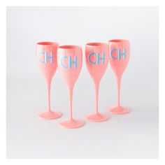 three pink wine glasses with the word ch on them are lined up against a white background