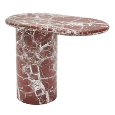 a red marble table with white veining on the top and bottom, against a white background