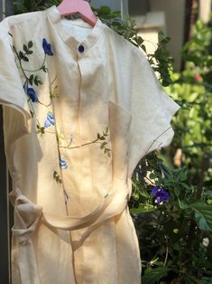 ❤ The beige linen hand embroidered dress is very soft, skin friendly, breezy and comfortable.  ❤ Item description: - A lovely dress with embroidered butterfly pea flower motifs. - Has 2 hidden sides pockets and 1 linen belt. - Material: linen, embroidery threads. - Environmentally friendly. - This dress is very useful, go with any outfit, that can be used to go to school, go out, go shopping.    It is a perfect gift for yourself or your beloved.  ❤ Care instructions:       The best way to wash embroidery cloth is to put it in soapy water (with a mild detergent and cold water at 86 ºF/30oС) for 20 minutes. Try to not wash the item with other clothing that might cause damage, such as zippers, buttons or different colors. You wash it by hand, and if you have dirty patches on your garment, you Beige Embroidered Summer Dress, Summer Beige Embroidered Dress, Beige Linen Dress For Spring Garden Party, Beige Floral Embroidered Dress For Summer, Beige Floral Embroidered Summer Dress, Elegant Summer Linen Dress With Floral Embroidery, Beige Linen Dress With Floral Embroidery, Embroidered Linen Dress For Summer Garden Party, Spring Garden Party Linen Embroidered Dress