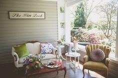 a living room filled with furniture and flowers