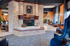 a living room filled with furniture and a fire place in the middle of a room