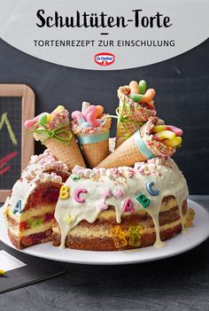 the cake is decorated with ice cream and candies, as well as letters on it