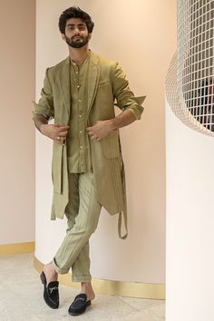 Featuring a sage green overcoat in a cotton linen base. It is paired with a matching belt.  FIT: True to size. COMPOSITION: Cotton linen. CARE: Dry clean only Indian Wedding Outfits For Men Classy, Indian Wedding Outfits For Men, Engagement Outfits Indian, Sangeet Outfit For Men, Indo Western Outfits For Men, Green Overcoat, Jatin Malik, Indo Western Dress For Men, Indian Wedding Suits Men