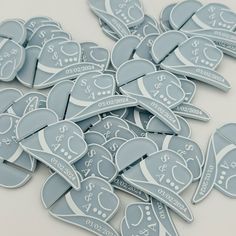 a pile of blue and white stickers sitting on top of a table next to each other