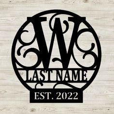 the last name for this personalized sign is shown in black and white on wood