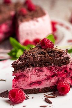 a piece of cake with raspberries and chocolate shavings