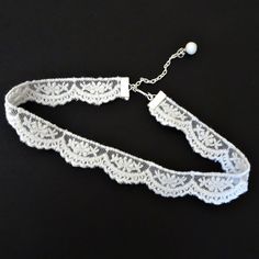 Lovely white scalloped pattern lace is featured in this choker necklace.  The lace is fastened with silver crimp bars and there is a matching metal chain length for adjustable sizing from 13" - 15". The width of the lace is 5/8". Silver metal extension chain is accented with a white glass bead dangle and there is a silver hook closure on the choker. All of my jewelry items come boxed and ribbon tied and tagged for easy gifting. Adjustable Lace Jewelry For Parties, Adjustable Lace Necklaces For Party, Lace Trim Choker Jewelry For Party, Lace Trim Choker For Party, Lace Choker Jewelry Gift, Lace Trim Choker Jewelry Gift, Lace Choker Jewelry As Gift, Elegant Lace Choker With Lace Trim, Lace Choker Jewelry For Gifts