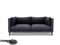 a black couch with two pillows on it and the words wondymoon design