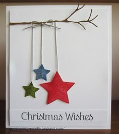 a christmas card with three stars hanging from it