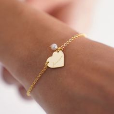 Elevate your style with our Personalized Heart Bracelet! Handcrafted with real pearls, this elegant bracelet is the perfect gift for her on any occasion. Whether it's a birthday, anniversary, or Christmas, this Name Bangle Bracelet adds a touch of sophistication to any outfit. This Name Engraved Bracelet for Mom features a delicate heart charm, adding a sentimental touch to your gift. Personalize it with your loved one's name for a truly special touch. Key Features: * Bracelet measures 16mm * Ma Gold Beaded Bracelet For Valentine's Day Personalized Gift, Personalized Gold Beaded Bracelet For Valentine's Day, Pearl Bracelet Jewelry As Gift, Pearl Heart Bracelet For Valentine's Day Gift, Elegant White Pearl Bracelet With Heart Charm, Elegant Beaded Bracelet With Heart Charm For Valentine's Day, Elegant Heart-shaped Charm Bracelet For Weddings, Elegant Wedding Charm Bracelet With Heart Charm, Pearl Heart Bracelet Gift