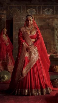 a woman in a red and gold bridal gown