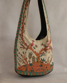 This bag offers a storybook scene depicted in shades of beige, green, rust and pink. The Tree of Life, a symbol of harmony and connection, is set in an Indian folk landscape bedecked with sprouting flowers, pleasant peacocks, and a temple that peaks up over the horizon. With this lovely picture rendered on a sturdy cotton messenger bag, the Tree of Life becomes a charming accessory that goes wherever you do! Tree of Life Indian folk art messenger bag Made of 100% cotton Bag base measures 16x11x5 Hippie Backpack Soul Flower (soulflower Clothing), Tree Of Life Symbol, Beige And Green, Happy Hippie, Hippie Bags, Indian Folk Art, All I Ever Wanted, The Tree Of Life, Shades Of Beige