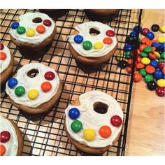 there are many decorated cookies on the cooling rack