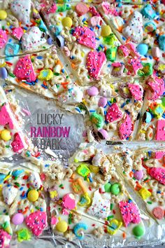 lucky rainbow barkie cake with white frosting and sprinkles on it