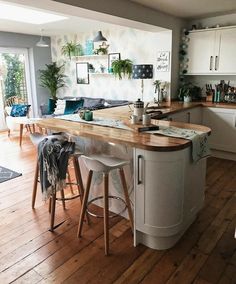 a kitchen with an island and stools in it