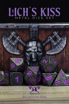 a metal dice set with purple numbers and an image of a knight on the front