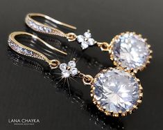 two pairs of earrings with diamonds on them