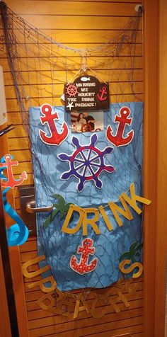 a door decorated with magnets and paper cutouts that say drink, anchor, life saver