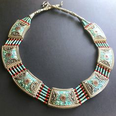 A Chunky And Heavy Necklace (Weighs About 100 Grams) With Multiple Strands And 7 Rectangular Silver Pieces Around The Neck. Fits High Up On The Chest And Frames The Neck In A Wide Bib Shape. Features Turquoise And Red Coral Beads, Turquoise Inlay, Tibetan Antique Silver Beads, And A Rustic Hook And Eye Closure. A One Of A Kind Handmade Find. Colorful, Ethnic, And Bold. Heavy Necklace, Necklace Big, Coral Beads, Vintage Turquoise, Silver Pieces, Red Coral, Silver Beads, Womens Jewelry Necklace, Turquoise Necklace