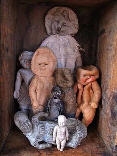 an old wooden box filled with different types of teddy bears and other small figurines