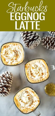 four mugs filled with eggnog latte and topped with pine cones