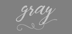 the word gray written in cursive writing on a grey background with white ink