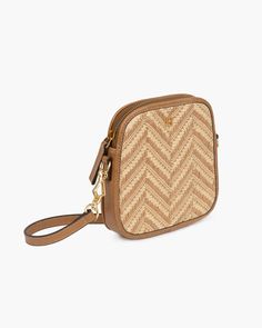 A small women's designer crossbody bag for sale online with zip top closure is crafted of chevron pattern woven raffia framed with rich calf leather. The leather strap is easy to adjust from shoulder to crossbody length using gold plated brass collar studs. This petite shape holds a phone, wallet, cards and lipstick. Inside sumptuous microfiber suede lining with patch pocket. Dimensions: Length: 6.5"(16.5cm), Width: 1.25"(3.2cm), Height: 6.5"(16.5cm) Crossbody strap adjusts from 19"(48.2cm) to 2 Luxury Woven Leather Crossbody Straw Bag, Designer Straw Crossbody Bag For Travel, Designer Crossbody Straw Bag For Travel, Luxury Crossbody Straw Bag For Travel, Luxury Travel Straw Crossbody Bag, Luxury Travel Crossbody Straw Bag, Luxury Woven Straw Crossbody Bag, Tan Woven Leather Travel Bag, Elegant Woven Leather Crossbody Straw Bag