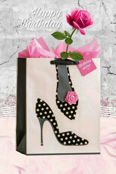 a pink rose is in a black and white shoe gift bag with the words happy birthday on it