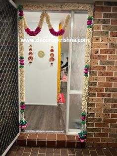 an entrance decorated with flowers and garlands