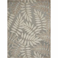 a rug with leaves on it in grey and white colors, the rug is made out of