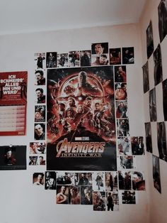 the avengers poster is hanging on the wall next to many pictures and magnets that have been placed around it