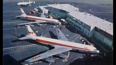 two airplanes are parked on the tarmac at an airport with other planes in the background