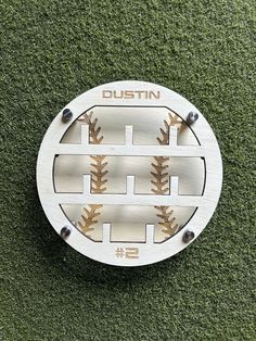 a baseball plate with the name dustin written on it in white and brown stitching