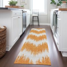 an orange and white rug in a kitchen