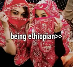 two women in red headscarves with the words being ethiopian > > > on them