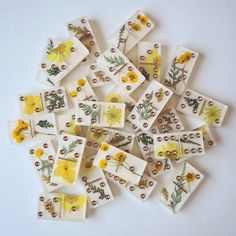 small yellow and white tiles with flowers on them