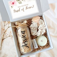 an open box with candles, cookies and other items