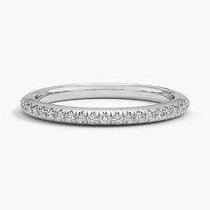 a white gold wedding band with rows of diamonds on the inside and outside of it