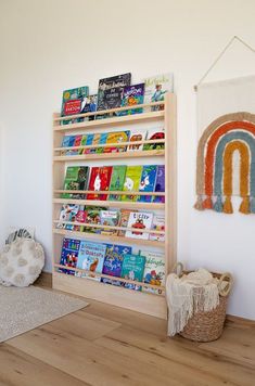 a bookshelf in the corner of a room filled with children's books