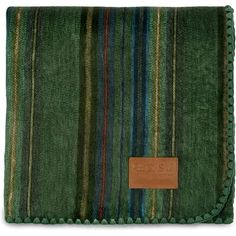 a green and blue striped blanket with leather tag